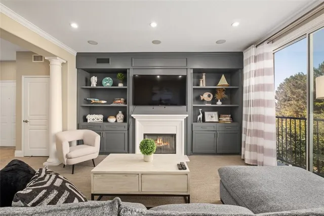 a living room with fireplace furniture and a flat screen tv