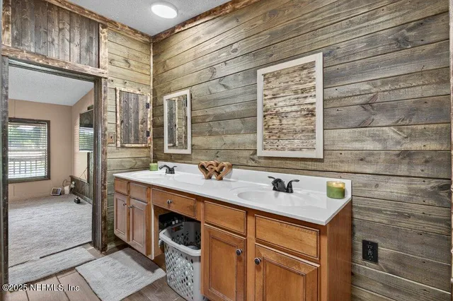 a bathroom with a sink a toilet and shower curtain