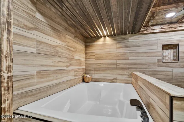 a bedroom with furniture and a chandelier fan