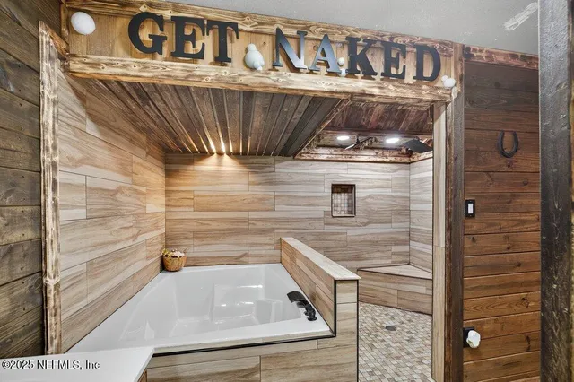 a kitchen with stainless steel appliances granite countertop a refrigerator a stove and a sink