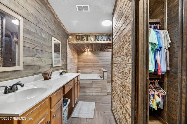a kitchen with stainless steel appliances granite countertop a sink and a wooden cabinets
