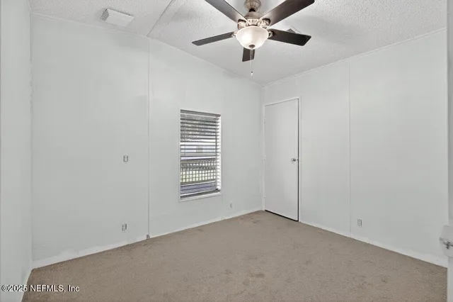 a view of an empty room with a balcony