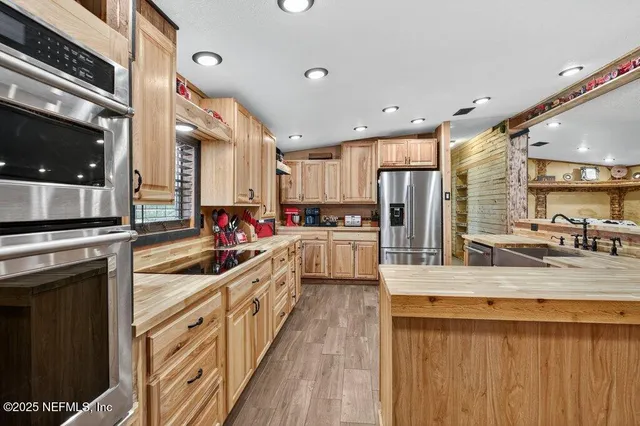 an aerial view of residential houses with outdoor space and trees