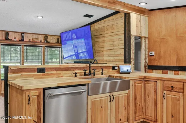 a view of a grassy field with trees in the background