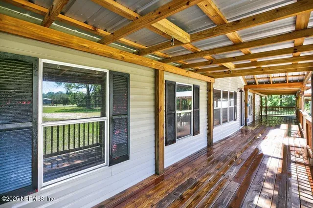 an aerial view of a houses with a yard