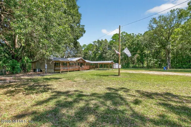 a bathroom with a toilet sink and a large mirror