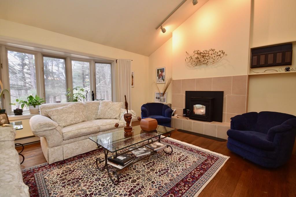 97 Hulst Road Amherst, MA 01002 - Photo 3 of 30 a living room with furniture a rug and a fireplace
