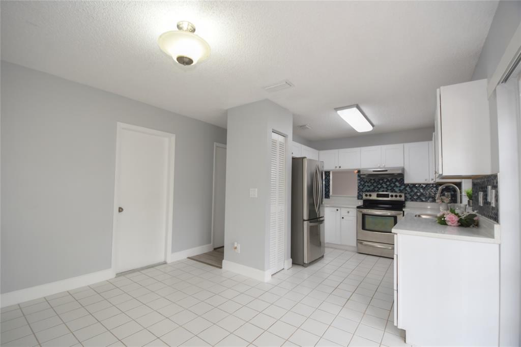 4801 Grapevine Way, Unit 4801 Davie, FL 33331 - Photo 13 of 38 a kitchen with refrigerator and cabinets