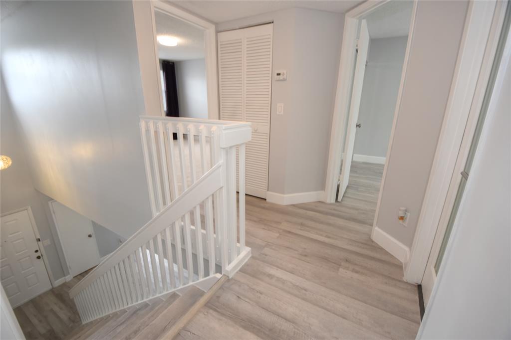 4801 Grapevine Way, Unit 4801 Davie, FL 33331 - Photo 19 of 38 a view of a hallway with wooden floor and staircase