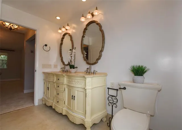 a bathroom with a toilet a sink and a mirror