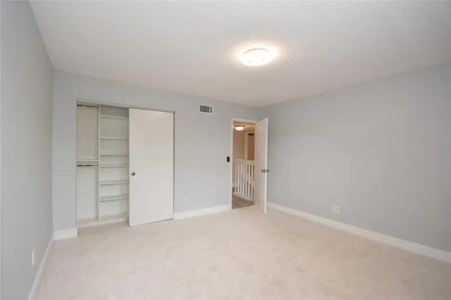 a view of an empty room and closet area
