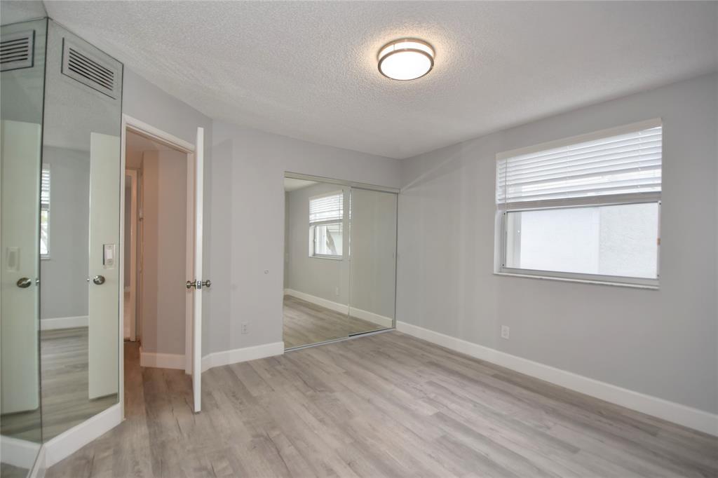 4801 Grapevine Way, Unit 4801 Davie, FL 33331 - Photo 32 of 38 an empty room with wooden floor and windows