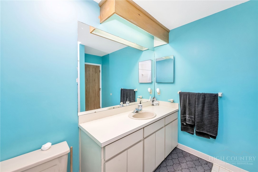 939 Don Bare Road Jefferson, NC 28640 - Photo 19 of 49 a bathroom with a sink a toilet and mirror