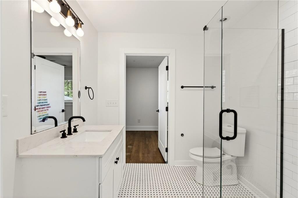 1344 Midlawn Drive Decatur, GA 30032 - Photo 31 of 87 a bathroom with a sink a toilet and a mirror