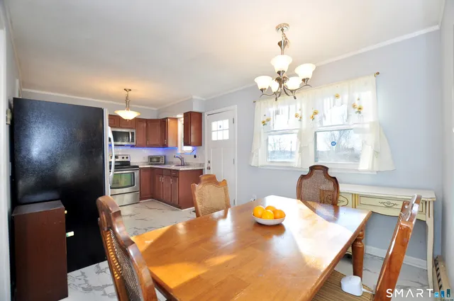 a view of a dining room with furniture and a chandelier