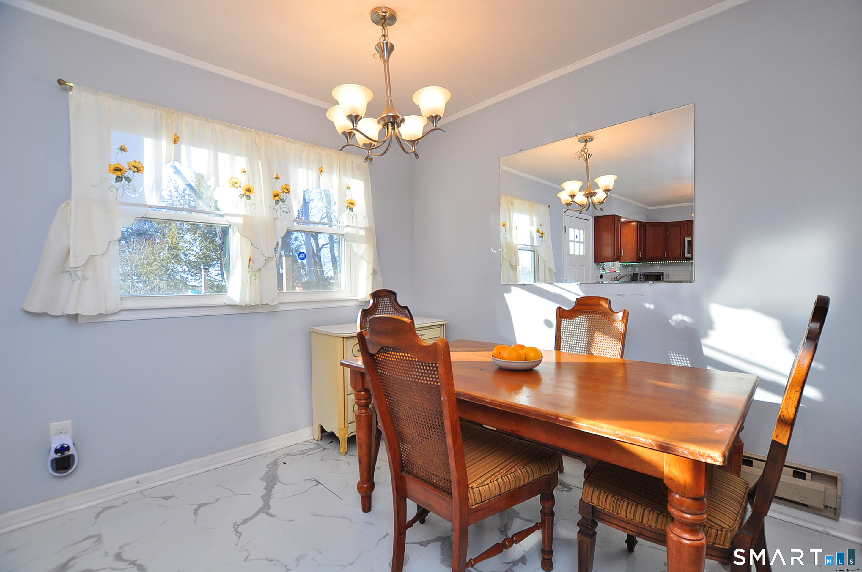 8 Cornfield Road Waterbury, CT 06704 - Photo 15 of 39 a dining room with wooden floor a chandelier a wooden table and chairs