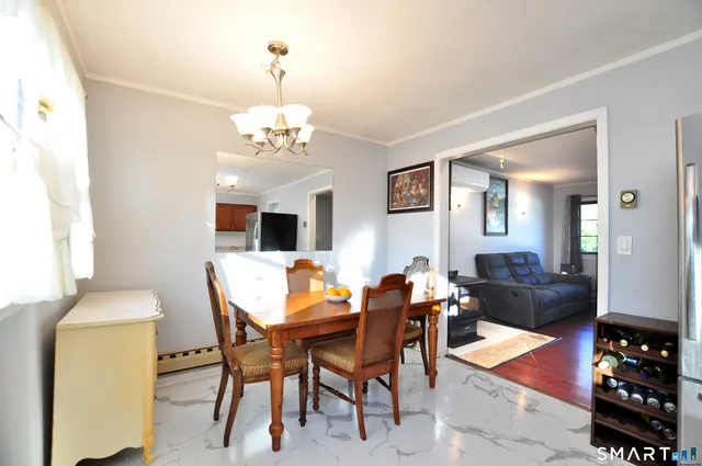 a dining room with furniture and wooden floor