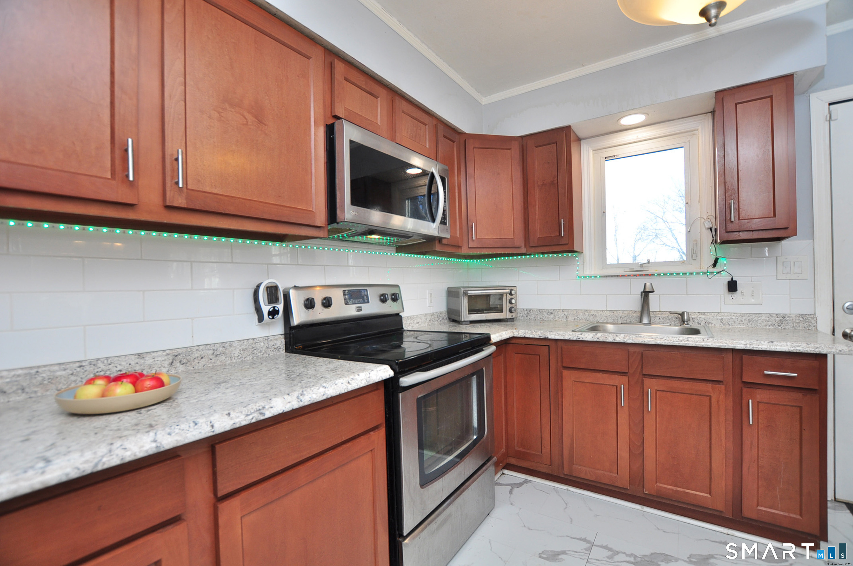 8 Cornfield Road Waterbury, CT 06704 - Photo 17 of 39 a kitchen with stainless steel appliances granite countertop a sink stove and microwave