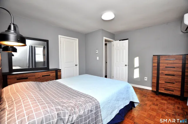 a bedroom with a bed and a dresser