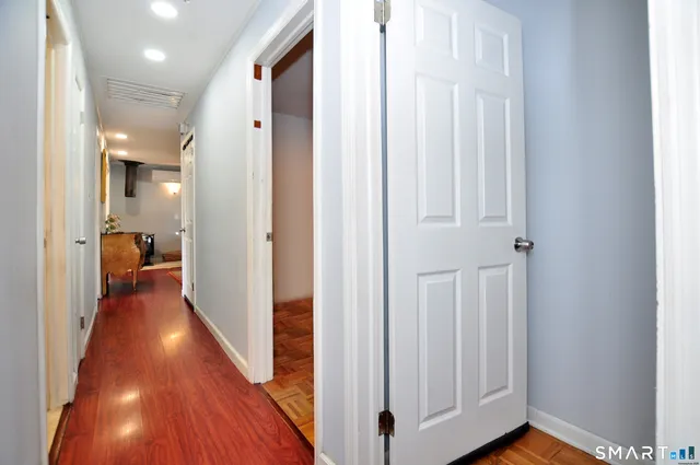 a view of a hallway with wooden floor