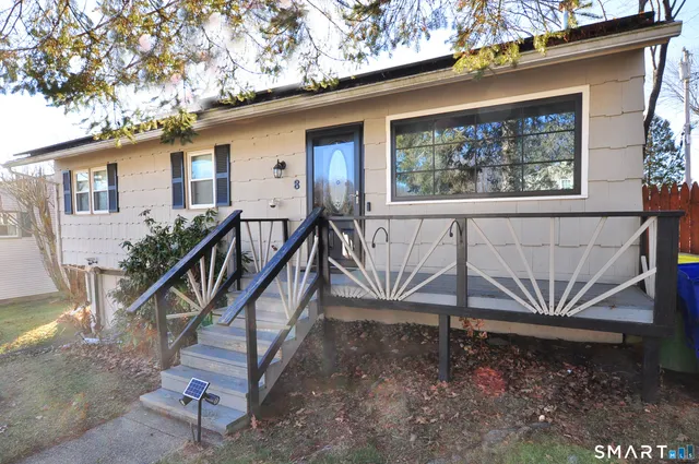 a view of a house with backyard and deck