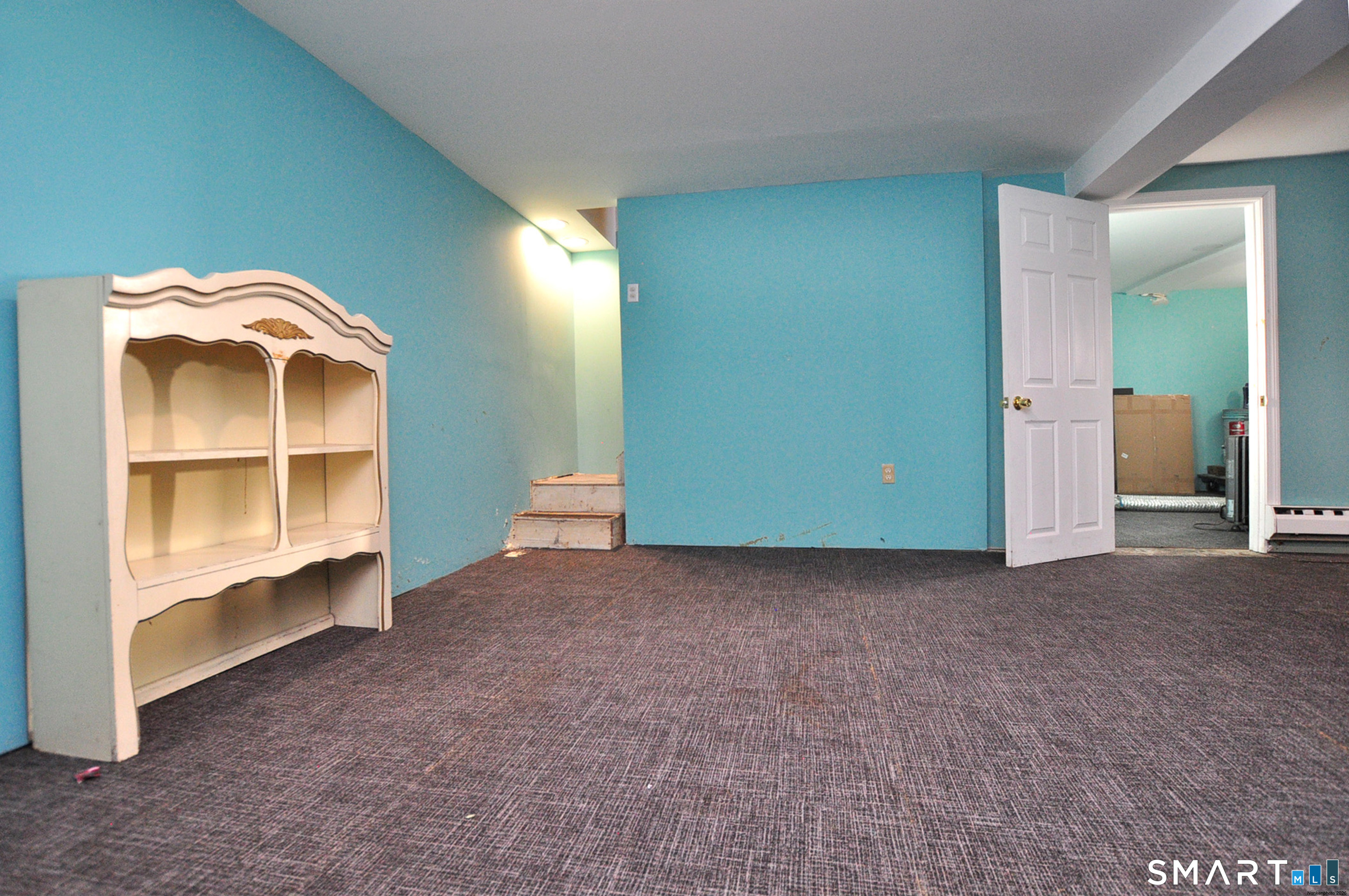 8 Cornfield Road Waterbury, CT 06704 - Photo 32 of 39 an empty room with a bench and cabinet