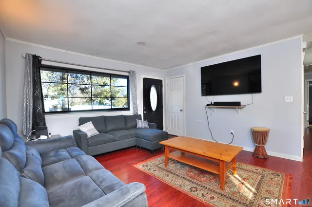a living room with furniture and a flat screen tv