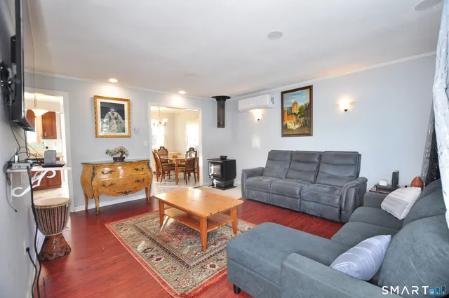a living room with furniture and wooden floor