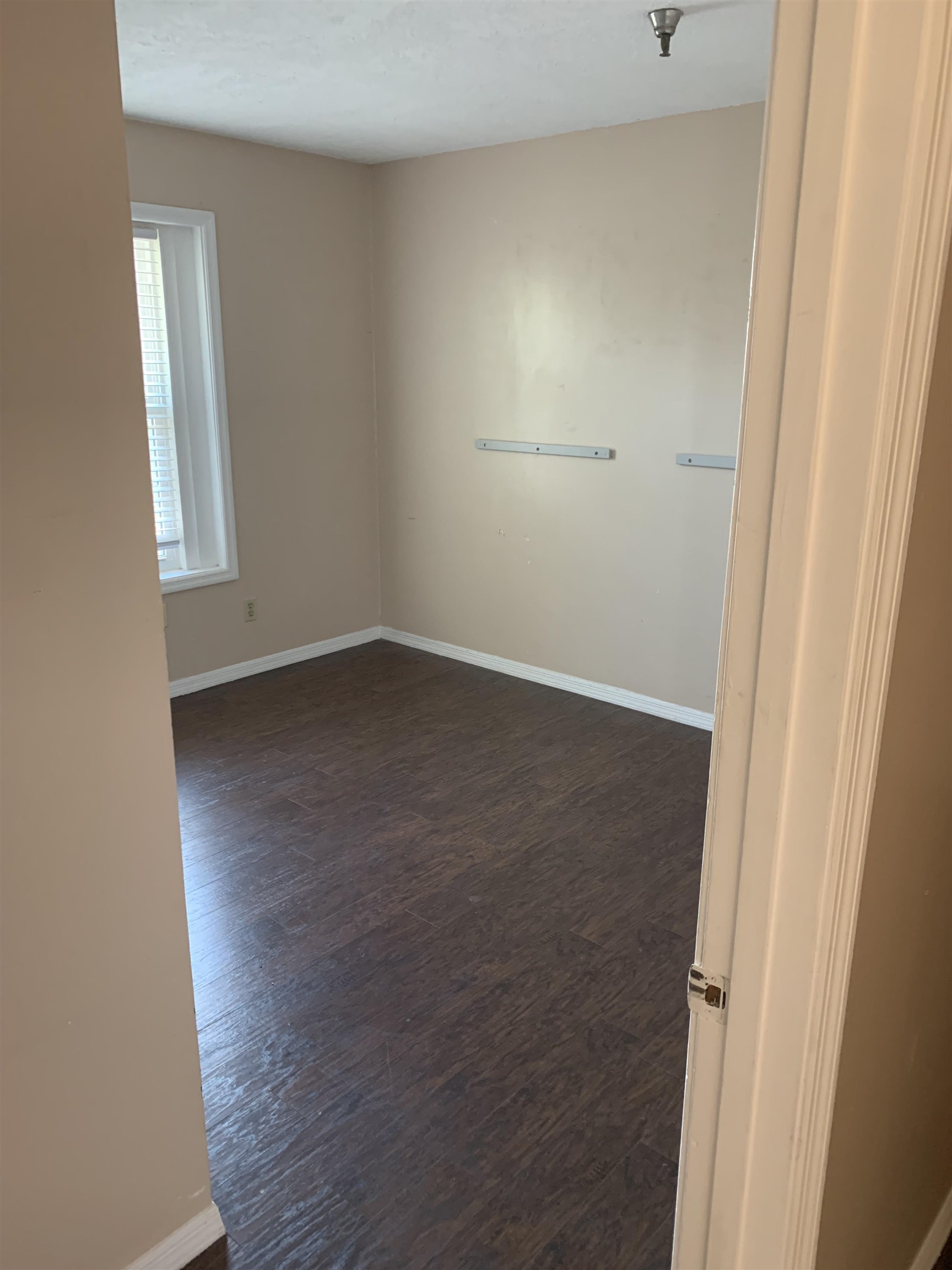 6225 A1A South, Unit D St. Augustine, FL 32080 - Photo 5 of 11 an empty room with wooden floor and windows