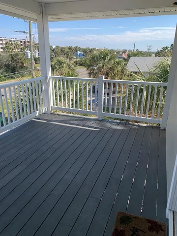 a view of balcony with wooden floor