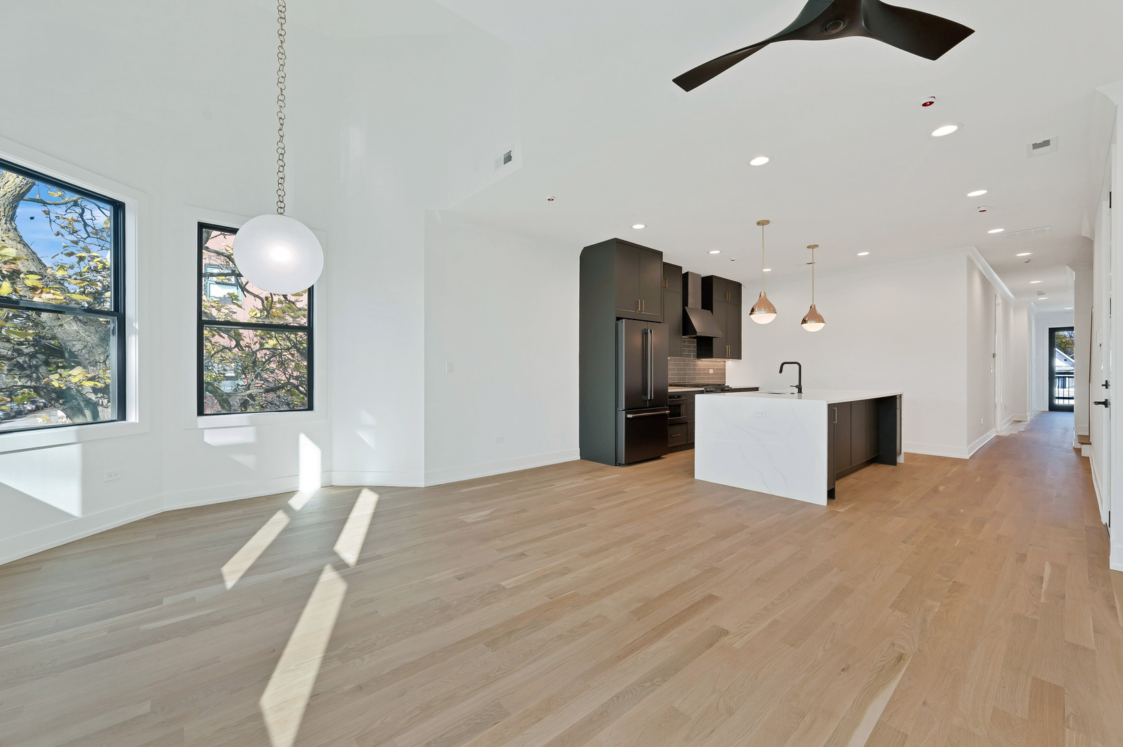 1404 West George Street, Unit 1 Chicago, IL 60657 - Photo 5 of 12 a view of an empty room with a kitchen and a window