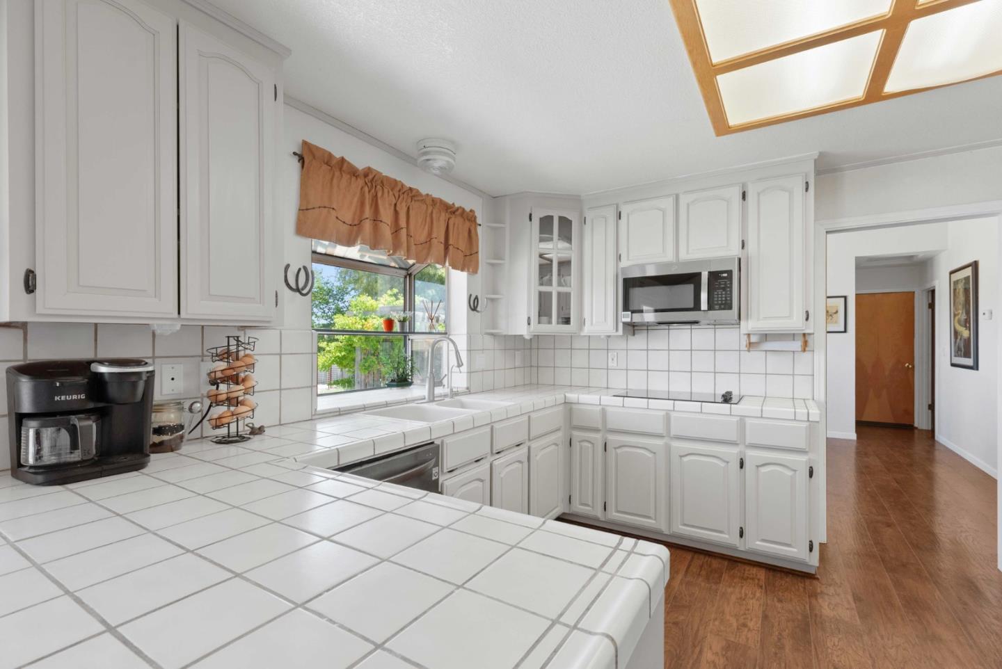 1150 Wright Road Hollister, CA 95023 - Photo 33 of 68 a kitchen with stainless steel appliances a sink a stove a refrigerator cabinets and a window