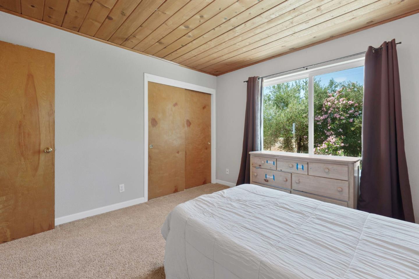 1150 Wright Road Hollister, CA 95023 - Photo 57 of 68 a bedroom with a large bed and a large window