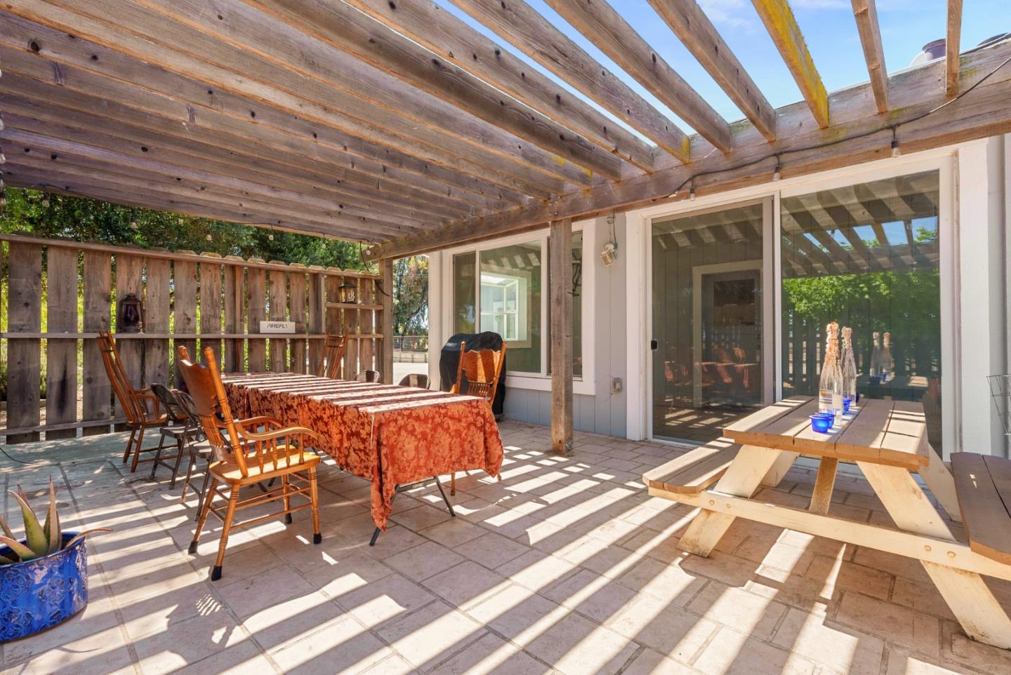 1150 Wright Road Hollister, CA 95023 - Photo 64 of 68 a view of a patio with table and chairs with wooden floor and fence