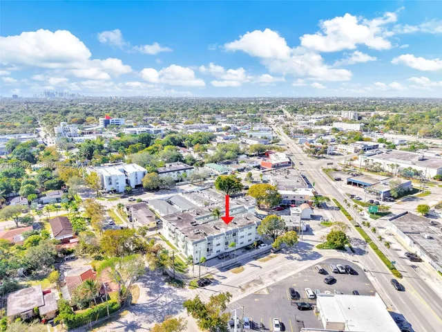an aerial view of residential houses with city view