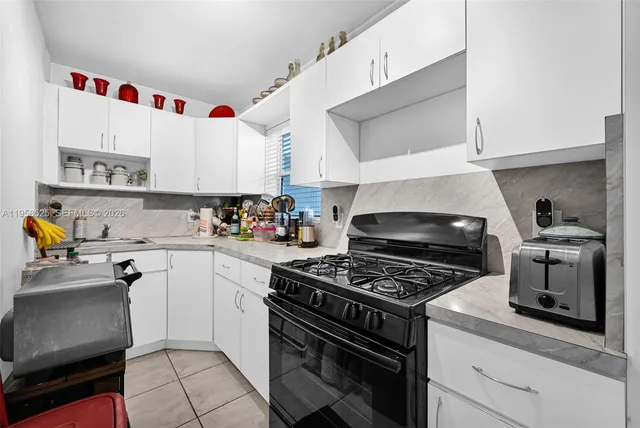 a kitchen with cabinets and appliances