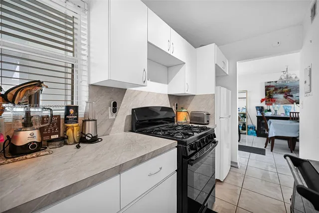 a kitchen with a sink a stove and cabinets