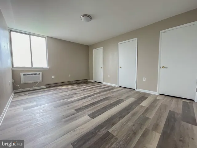 a view of room with window and hardwood floor