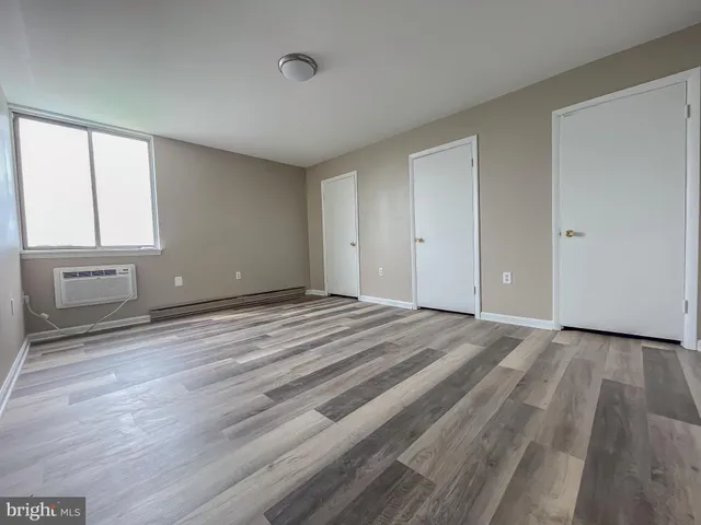 a view of room with window and wooden floor