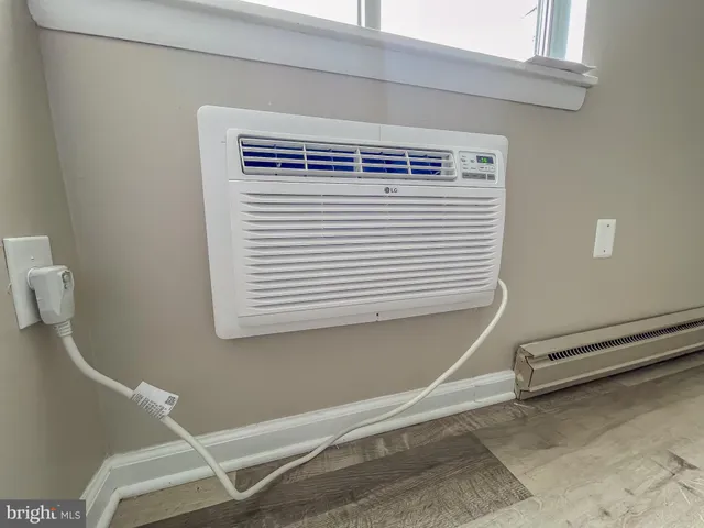 a view of a room with a window and a ceiling fan