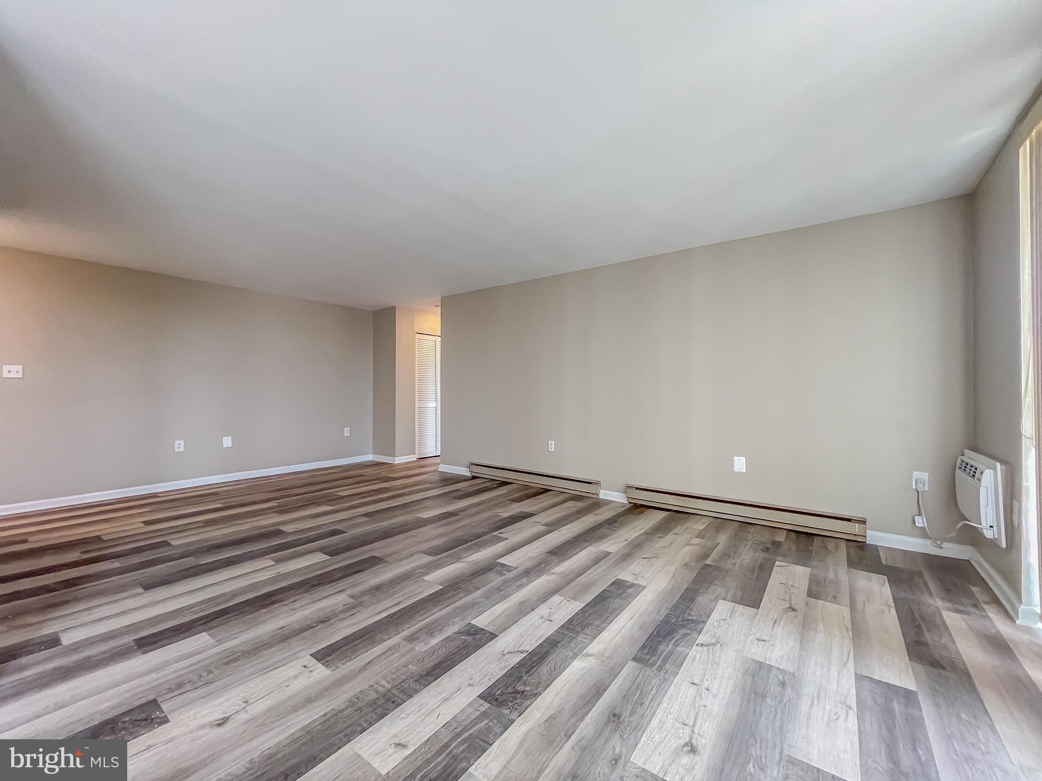 3245 Rio Drive, Unit 610 Falls Church, VA 22041 - Photo 8 of 27 a view of empty room with wooden floor