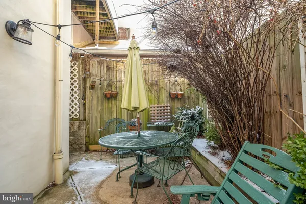 a view of a balcony with a table and chairs