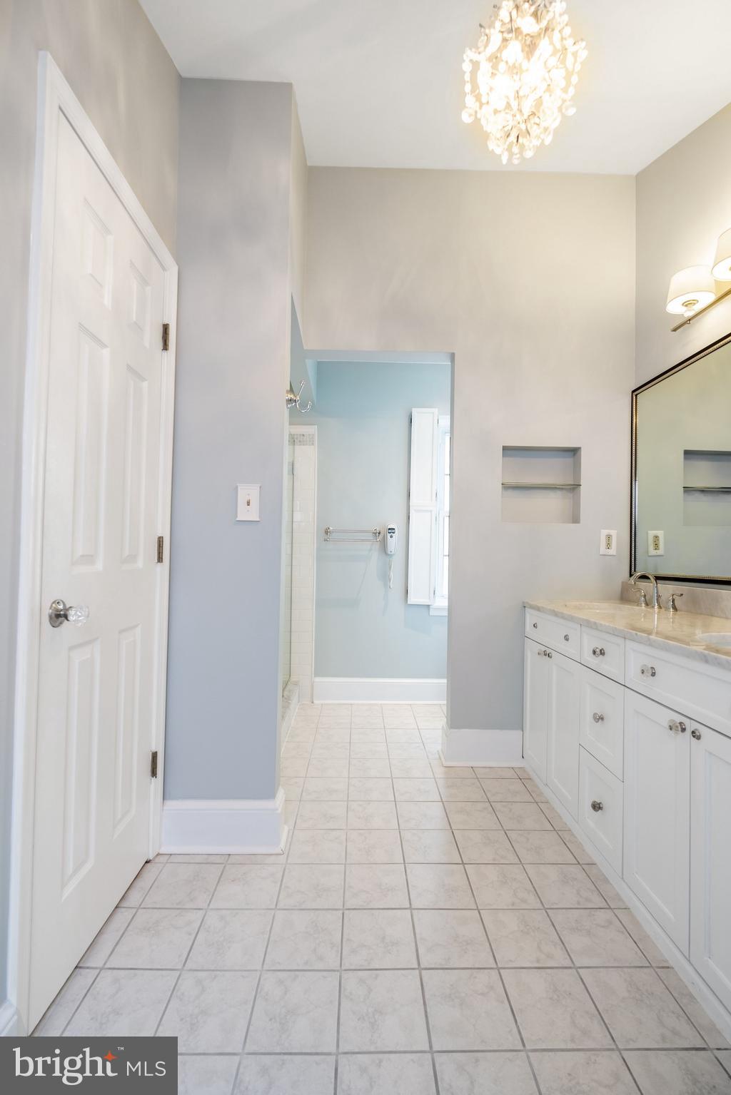 908 South Front Street Philadelphia, PA 19147 - Photo 16 of 27 a spacious bathroom with a granite countertop sink a mirror and a vanity