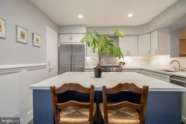 a kitchen with a sink cabinets and appliances