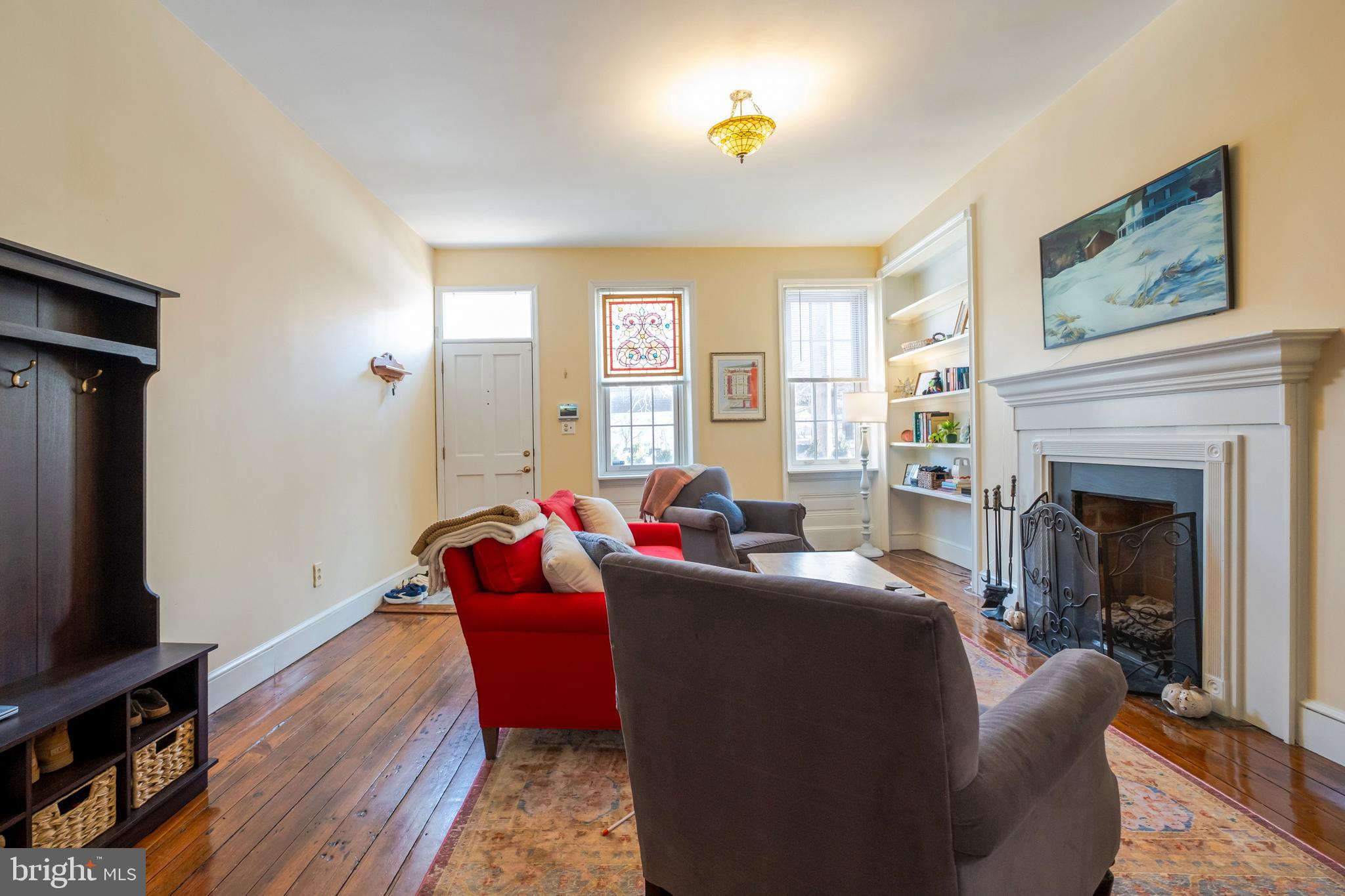 908 South Front Street Philadelphia, PA 19147 - Photo 9 of 27 a living room with furniture a fireplace and a flat screen tv