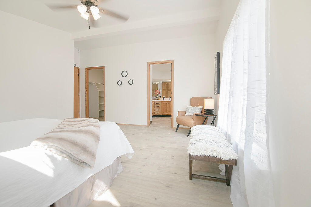 17231 Downey Road Bend, OR 97707 - Photo 16 of 40 a bedroom with a bed and a chandelier