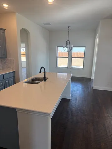a close view of a sink a window and wooden floor