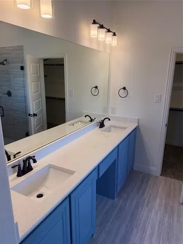 a bathroom with a tub sink and mirror