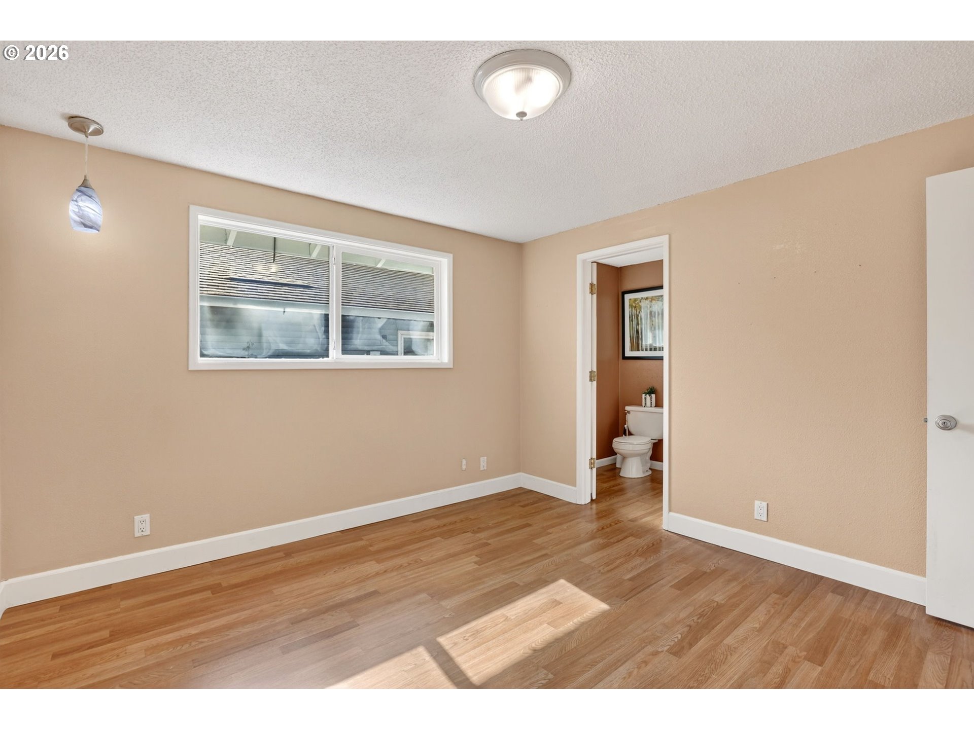 640 Stonehill Street Gladstone, OR 97027 - Photo 29 of 48 an empty room with wooden floor and windows