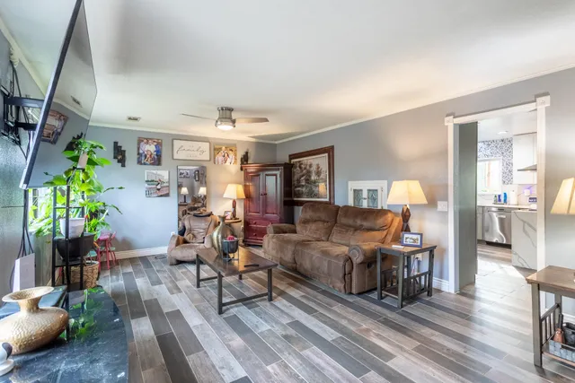 a dining room with furniture and wooden floor